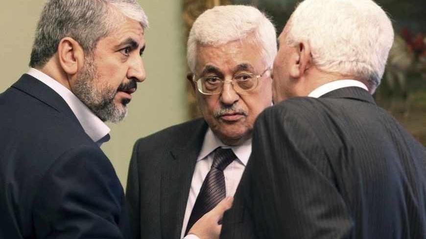 Hamas leader Khaled Meshaal (L) and Palestinian President Mahmoud Abbas (C) talk with an official during their meeting in Cairo November 24, 2011. The leaders of Fatah and Hamas met for the first time in six months on Thursday and hailed progress toward ending Palestinian divisions that has led to separate governments in the West Bank and Gaza Strip, but there was no sign of a breakthrough. REUTERS/Mohamed Al Hams/Handout (EGYPT - Tags: POLITICS) FOR EDITORIAL USE ONLY. NOT FOR SALE FOR MARKETING OR ADVER
