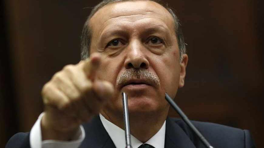 Turkey's Prime Minister Tayyip Erdogan addresses members of parliament from his ruling AK Party (AKP) during a meeting at the Turkish parliament in Ankara June 25, 2013. Turkish anti-terrorism police detained 20 people in raids in the capital Ankara on Tuesday in connection with weeks of anti-government protests across the country, media reports said. The unrest began at the end of May when police used force against campaigners opposed to plans to redevelop a central Istanbul park. The protest spiralled int