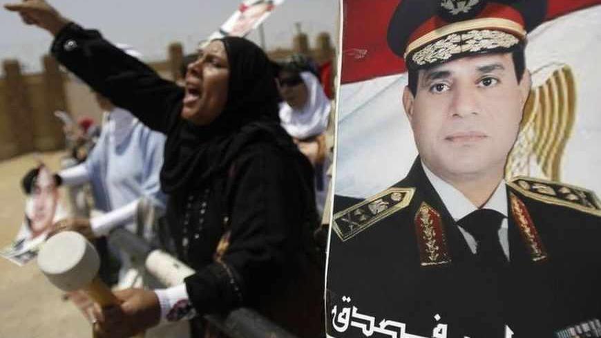 Supporters of Egypt's former President Hosni Mubarak shout slogans against members of the Muslim Brotherhood and supporters of ousted Egyptian President Mohamed Mursi near a poster of Egypt's armed forces chief General Abdel Fattah al-Sisi, outside a police academy before Mubarak's trial in Cairo July 6, 2013. The slow-motion retrial of former Egyptian autocrat Hosni Mubarak dragged on at snail's pace on Saturday, impervious to the latest upheaval in the country he ruled for 30 years - the military overthro