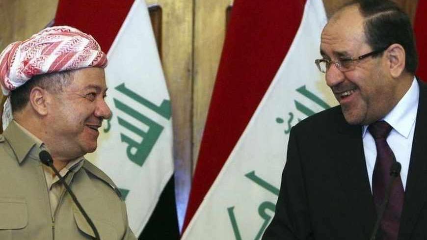 Iraqi Prime Minister Nuri al-Maliki (R) and Iraqi Kurdish President Masoud Barzani (L) talk as they hold a joint news conference in Baghdad, July 7, 2013. Barzani visited Baghdad on Sunday for the first time in more than two years, in a symbolic step to resolve disputes between the central government and the autonomous region over land and oil. The visit follows an equally rare trip by Iraqi Prime Minister Nuri al-Maliki who met Barzani in Kurdistan last month, breaking ice between leaders who have repeated