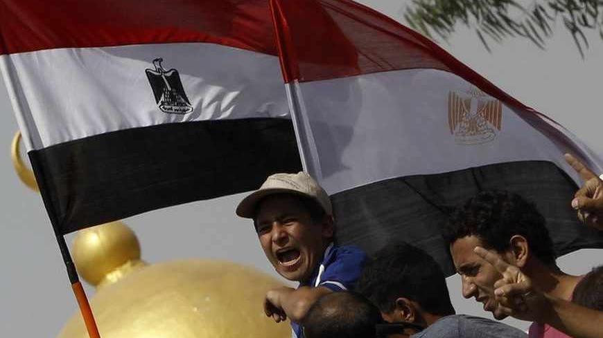 Members of the Muslim Brotherhood and supporters of deposed Egyptian President Mohamed Mursi shout slogans in front of army soldiers at Republican Guard headquarters in Nasr City, a suburb of Cairo July 8, 2013. At least 51 people were killed on Monday when demonstrators enraged by the military overthrow of Egypt's elected Islamist president said the army opened fire during morning prayers outside the Cairo barracks where Mursi is believed to be held. REUTERS/Amr Abdallah Dalsh (EGYPT - Tags: POLITICS CIVI