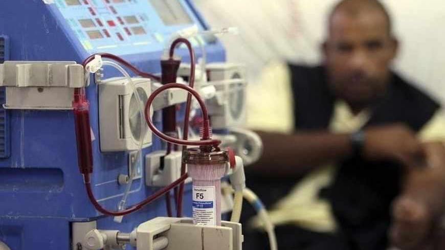 A Palestinian man awaits treatment by dialysis inside the kidney section at al-Shifa hospital in Gaza October 27, 2008. The nearly empty corridors of Gaza's main Shifa Hospital testified to the ailing state of health care in the Hamas-controlled territory. A crisis-level shortage of drugs and spare parts for medical equipment and a two-month-old strike by health care workers have combined to add more misery to the lives of the 1.5 million inhabitants of the impoverished Gaza Strip. REUTERS/Suhaib Salem (GAZ