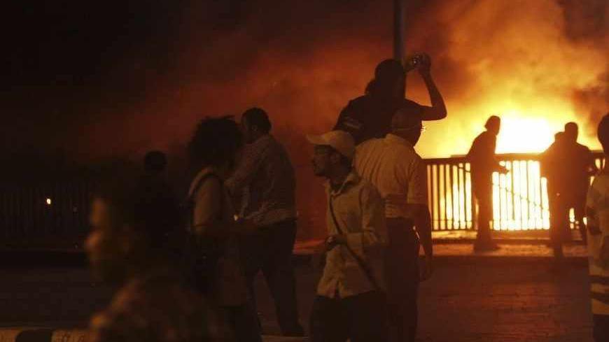 Anti-Mursi protesters are pictured during clashes with members of the Muslim Brotherhood and supporters of deposed Egyptian President Mohamed Mursi near Maspero, Egypt's state TV and radio station, near Tahrir square in Cairo July 5, 2013. Seventeen people were killed in violence in Egypt on Friday as supporters of deposed Islamist President Mohamed Mursi protested his overthrow by the army, state television said, quoting Health Ministry data.        REUTERS/Amr Abdallah Dalsh  (EGYPT - Tags: POLITICS CIVIL