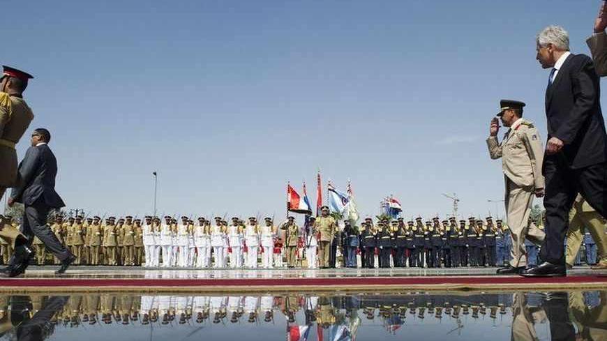 U.S. Defense Secretary Chuck Hagel (2nd R) walks with Egyptian army officials before laying a wreath at the Tomb of the Unknown Soldier in Cairo April 24, 2013. REUTERS/Jim Watson/Pool (EGYPT - Tags: POLITICS MILITARY) - RTXYY94