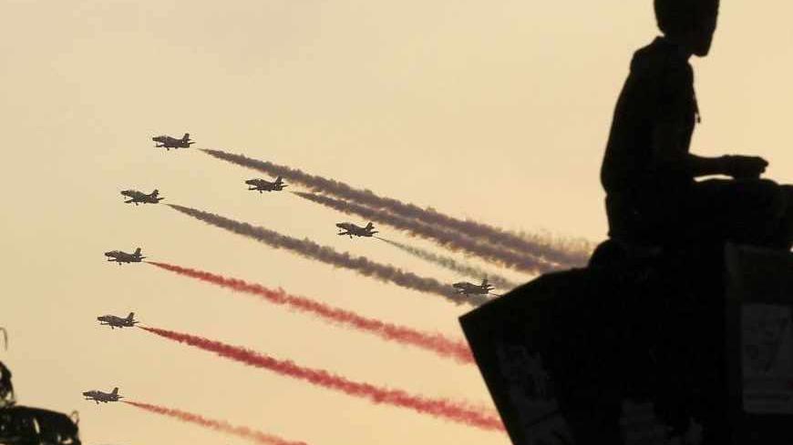 A man is silhouetted against the sunset as Egyptian military jets fly in formation over Tahrir square in Cairo July 4, 2013. The leader of the Muslim Brotherhood was arrested by Egyptian security forces on Thursday in a crackdown against the Islamist movement after the army ousted the country's first democratically elected president Mohamed Mursi. Adli Mansour, head of Egypt's constitution court, was sworn in as the interim head of state on Friday. REUTERS/Mohamed Abd El Ghany (EGYPT - Tags: POLITICS CIVIL 