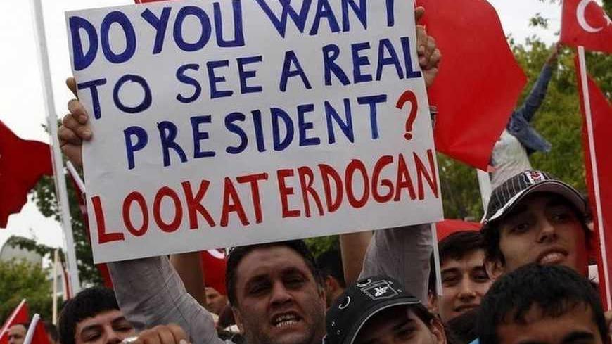 Supporters of Turkey's Prime Minister Tayyip Erdogan wave flags, hold banners and shout slogans as they wait for his arrival at Esenboga Airport in Ankara June 9, 2013.  Still by far the country's most popular politician, Erdogan has pressed ahead with government business as usual.  REUTERS/Umit Bektas (TURKEY - Tags: POLITICS CIVIL UNREST) - RTX10HD0