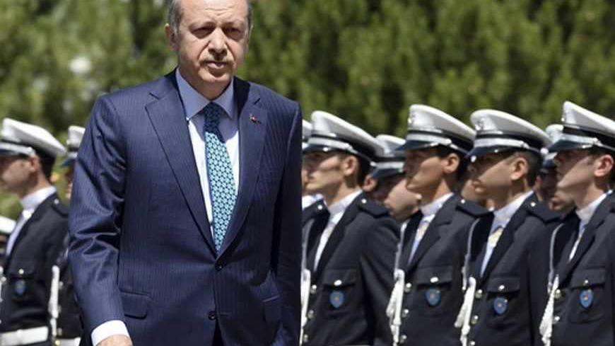Turkey's Prime Minister Tayyip Erdogan reviews students of the Police Academy upon his arrival to their graduation ceremony in Ankara June 24, 2013. REUTERS/Stringer (TURKEY - Tags: POLITICS CRIME LAW) - RTX10YXL