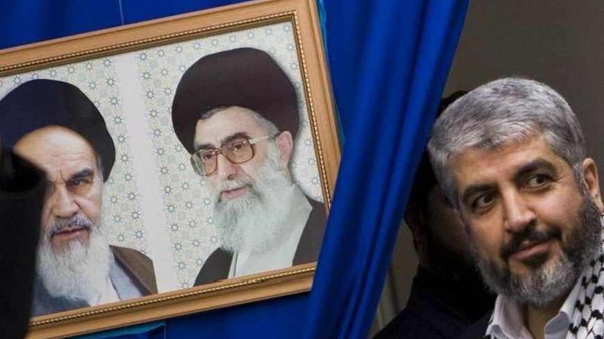 Hamas leader Khaled Meshaal (R) attends a rally in Tehran university February 2, 2009. A delegation from Hamas, headed by its leader Meshaal, arrived in Tehran on Sunday as part of a regional push to reinforce support for the Palestinian group after the Israeli invasion of Gaza. The portraits on the left are that of Late Leader Ayatollah Rouollah Khomeini (L) and Iran's Supreme Leader Ayatollah Ali Khamenei. REUTERS/Raheb Homavandi (IRAN) - RTXB5LP