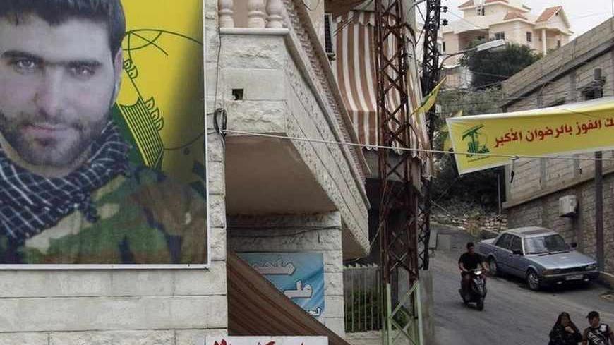 A poster of Mohamed Hassan Shehade, a Hezbollah fighter who died in the Syrian conflict, hangs on a building in Adloun town, south of Sidon in southern Lebanon, July 23, 2013. The European Union agreed on Monday to put the armed wing of Hezbollah on its terrorism blacklist, a move driven by concerns over the Lebanese militant group's involvement in a deadly bus bombing in Bulgaria and the Syrian war. REUTERS/Ali Hashisho (LEBANON - Tags: POLITICS CIVIL UNREST MILITARY CRIME LAW) - RTX11W1Q