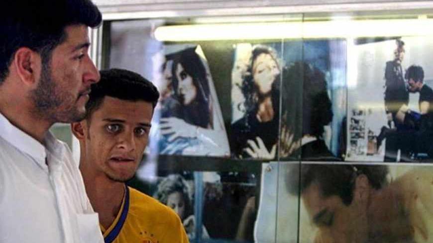 Iraqi men walk past posters advertising a pornographic film at a cinema
in Baghdad, April 30, 2003. Pornography and prostitution was officially
banned under the regime of Saddam Hussein until his ousting from power
by U.S.-led forces two weeks ago.

REUTERS/Zohra Bensemra - RTRMOD7