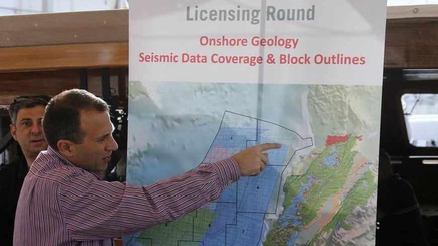 Caretaker Energy Minister Gebran Bassil points at a map during a tour of areas believed to have gas reserves, off Lebanon's coast near Beirut May 30, 2013. Offshore seismic surveys suggest Lebanon has at least 30 trillion cubic feet in just a small fraction of its Mediterranean waters Bassil said. Lebanon has selected 46 international oil companies to bid to explore for gas off its coast, where survey ships have been assessing prospects after discoveries in waters off neighbouring Israel and Cyprus. Pictur