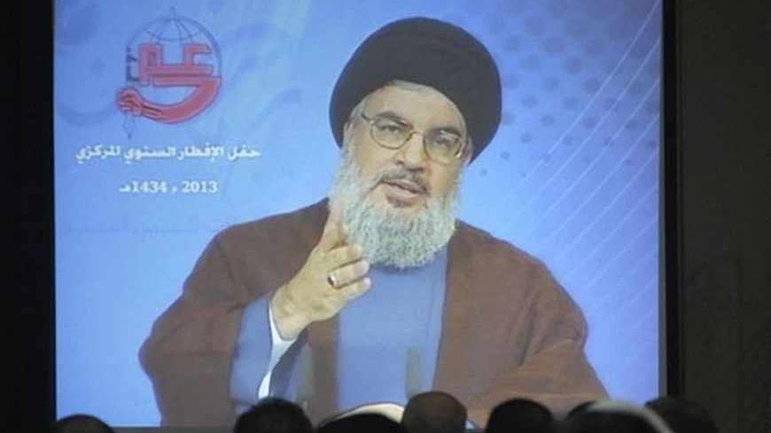 Lebanon's Hezbollah leader Sayyed Hassan Nasrallah addresses his supporters via a video conference during iftar, the breaking of fast meal, during the Islamic month of Ramadan in Beirut's southern suburbs July 19, 2013. REUTERS/Sharif Karim (LEBANON - Tags: POLITICS RELIGION) - RTX11S9O