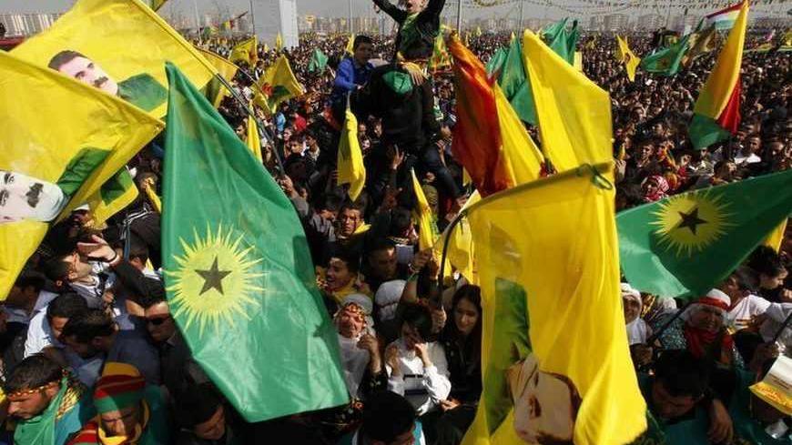 Demonstrators hold Kurdish flags and portraits of jailed Kurdistan Workers Party (PKK) leader Abdullah Ocalan during a gathering to celebrate Newroz in the southeastern Turkish city of Diyarbakir March 21, 2013. Jailed Kurdish rebel leader Abdullah Ocalan ordered his fighters on Thursday to cease fire and withdraw from Turkish soil as a step to ending a conflict that has killed 40,000 people, riven the country and battered its economy. Hundreds of thousands of Kurds gathered in the regional centre of Diyarb