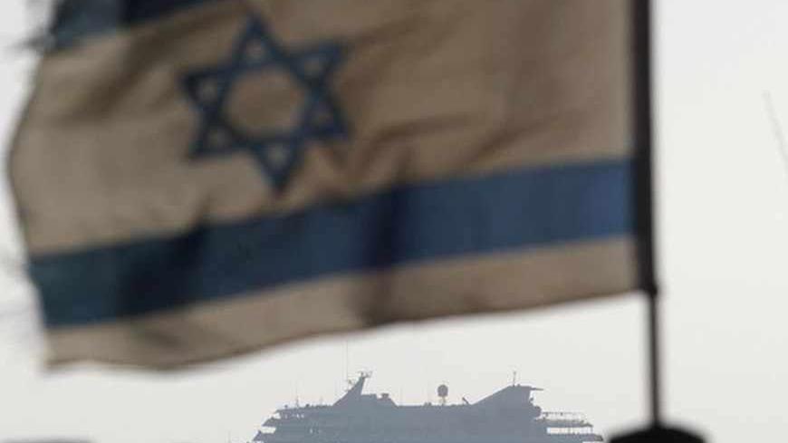 An Israeli flag flutters in the wind as a naval vessel (not seen) escorts the Mavi Marmara, a Gaza-bound ship that was raided by Israeli marines, to the Ashdod port May 31, 2010. Israeli marines stormed the Turkish aid ship bound for Gaza on Monday and 10 pro-Palestinian activists were killed, triggering a profound diplomatic crisis. REUTERS/Amir Cohen (ISRAEL - Tags: POLITICS CIVIL UNREST IMAGES OF THE DAY) - RTR2ELLI