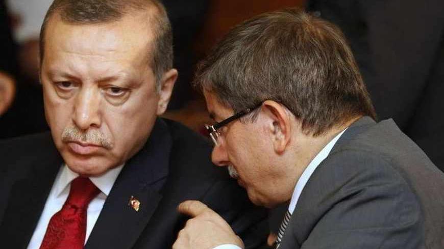 Turkey's Foreign Minister Ahmet Davutoglu (R) speaks with Turkish Prime Minister Tayyip Erdogan during a meeting at the government palace in Tunis September 15, 2011. Tunisia's new political order will show that Islam and democracy can co-exist just as they have in Turkey, Turkish Prime Minister Tayyip Erdogan said on Thursday. Erdogan, in Tunis on the second stop of a North African tour aimed at asserting Ankara's growing regional influence, said secularity should guarantee that people of all beliefs, as w