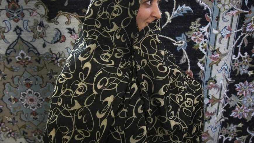 EDITORS' NOTE: Reuters and other foreign media are subject to Iranian restrictions on leaving the office to report, film or take pictures in Tehran. 
A worker stands in front of an Iranian handmade carpet at a carpet workshop in Kashan, 240 km (149 miles) south of Tehran November 13, 2011. Persian carpet weaving is a historical part of Iranian culture, dating back to as far as approximately 2,000 years ago. Persian carpets can be mostly divided into three size groups: large (3x4 metres), medium (2x3 metres