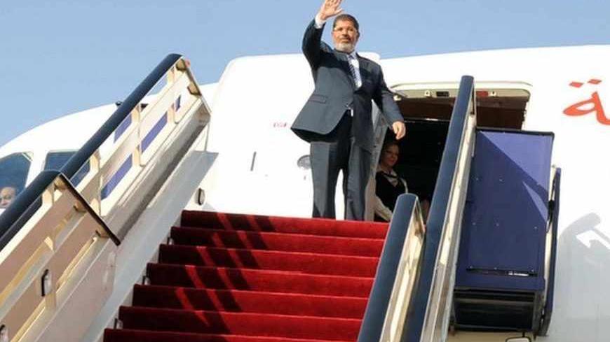 Egypt's President Mohamed Mursi waves at the end of his visit to the Mosque of Prophet Mohammed in Madinah July 12, 2012. REUTERS/Saudi Press Agency/Handout  (SAUDI ARABIA - Tags: POLITICS RELIGION) FOR EDITORIAL USE ONLY. NOT FOR SALE FOR MARKETING OR ADVERTISING CAMPAIGNS. THIS IMAGE HAS BEEN SUPPLIED BY A THIRD PARTY. IT IS DISTRIBUTED, EXACTLY AS RECEIVED BY REUTERS, AS A SERVICE TO CLIENTS - RTR34VN8