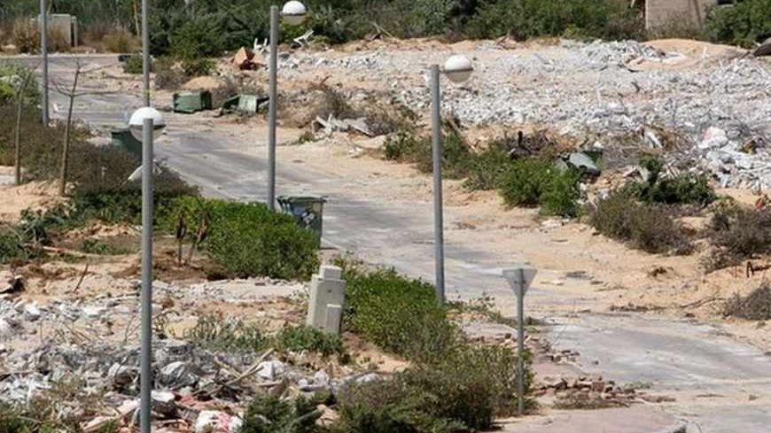 Rows of rubble cover ground after Israeli forces demolished houses in evacuated Jewish settlement of Ganei Tal in southern Gaza Strip.  Rows of rubble cover the ground after Israeli forces demolished houses in the evacuated Jewish settlement of Ganei Tal, in the Gush Katif settlements bloc, in the southern Gaza Strip, August 22, 2005. Israeli troops marched unopposed into the Gaza Strip's last Jewish settlement on Monday to complete the evacuation of the territory after nearly four decades of occupation. Bu