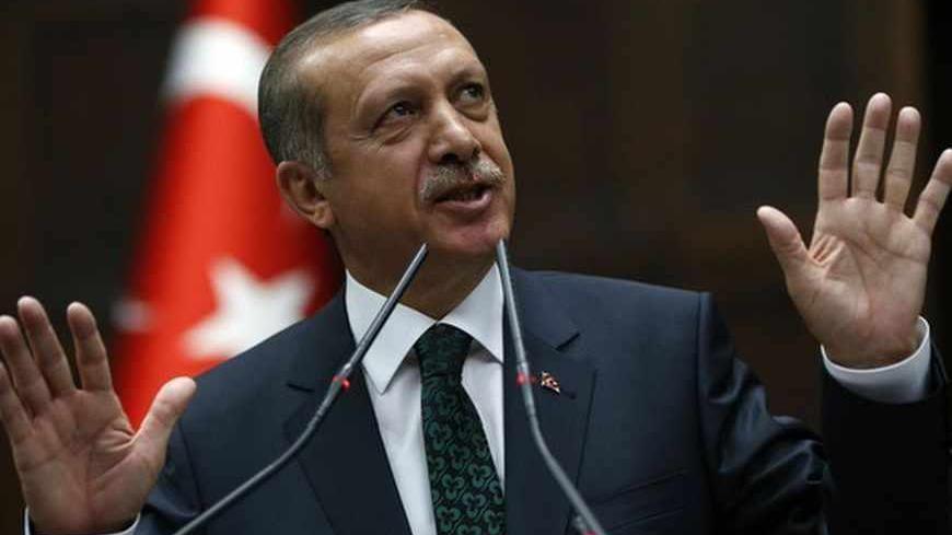 Turkey's Prime Minister Tayyip Erdogan addresses members of parliament from his ruling AK Party (AKP) during a meeting at the Turkish parliament in Ankara June 25, 2013. Turkish anti-terrorism police detained 20 people in raids in the capital Ankara on Tuesday in connection with weeks of anti-government protests across the country, media reports said. The unrest began at the end of May when police used force against campaigners opposed to plans to redevelop a central Istanbul park. The protest spiralled int