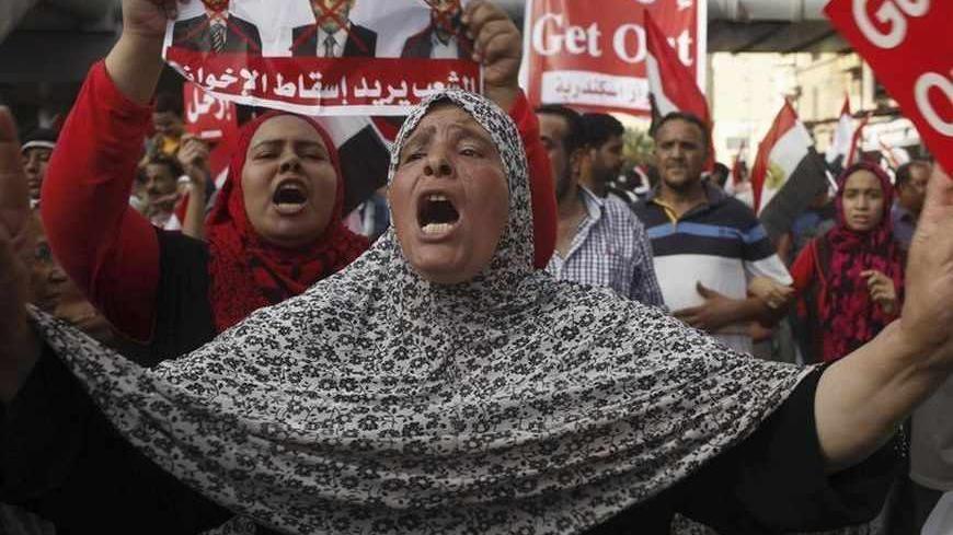 An anti-Mursi protester chants slogans during a massive protest in Alexandria, June 30, 2013. Egyptians poured onto the streets on Sunday, swelling crowds that opposition leaders hope will number into the millions by evening and persuade Islamist President Mohamed Mursi to resign. REUTERS/Asmaa Waguih (EGYPT - Tags: POLITICS CIVIL UNREST) - RTX1179M