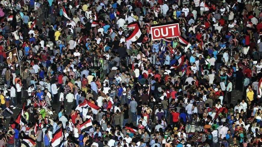 Protesters opposing Egyptian President Mohamed Mursi gather during a demonstration at Tahrir Square in Cairo June 30, 2013. Egyptians poured onto the streets on Sunday, swelling crowds that opposition leaders hope will number into the millions by evening and persuade Islamist President Mohamed Mursi to resign. REUTERS/Mohamed Abd El Ghany (EGYPT - Tags: POLITICS CIVIL UNREST TPX IMAGES OF THE DAY) - RTX117HY