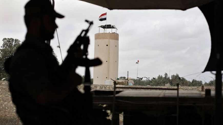 A member of Palestinian security forces loyal to Hamas rides in a pickup truck as he patrols the border area between Egypt and southern Gaza Strip July 1, 2013. Egyptian soldiers and members of Palestinian security forces loyal to Hamas are on alert to guard the border area after massive protests in Egypt, Hamas officials said. REUTERS/Ibraheem Abu Mustafa (GAZA - Tags: POLITICS) - RTX118IN