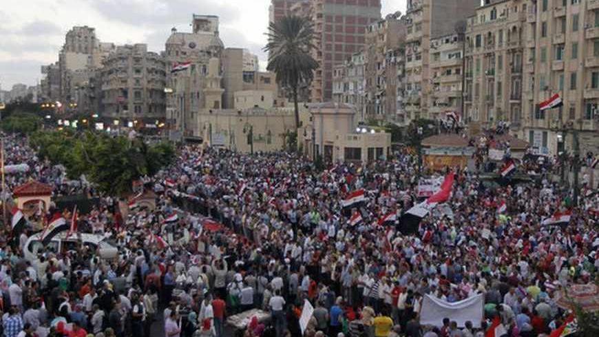 Protesters who are against ousted Egyptian President Mohamed Mursi celebrate in Alexandria July 7, 2013.  Hundreds of thousands of supporters and opponents of ousted Mursi gathered in Cairo and Alexandria on Sunday, two days after similar gatherings led to nationwide clashes that claimed more than 30 lives. REUTERS/Louafi Larbi (EGYPT - Tags: POLITICS CIVIL UNREST) - RTX11G92