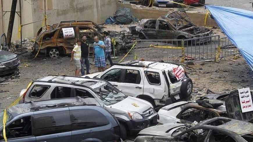 People inspect the site of the explosion that occurred on Tuesday in Beirut's southern suburbs July 10, 2013. A massive car bomb ripped through a Beirut stronghold of Lebanon's Hezbollah militant group that has been fighting alongside President Bashar al-Assad in Syria's civil war, wounding 53 people on Tuesday. None of those hurt were seriously wounded, Health Minister Hassan Khalil told Reuters, and there were no fatalities. REUTERS/Sharif Karim  (LEBANON - Tags: POLITICS CIVIL UNREST) - RTX11INJ