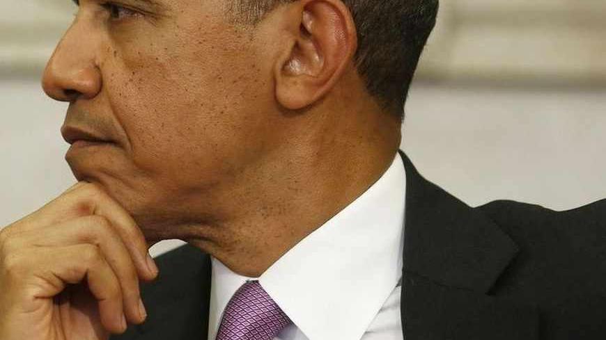 U.S. President Barack Obama sits next to Qatar Emir Sheikh Hamad bin Khalifa al-Thaniat (not pictured) as he speaks in the Oval Office of the White House in Washington, April 23, 2013.      REUTERS/Larry Downing  (UNITED STATES - Tags: POLITICS) - RTXYXDL
