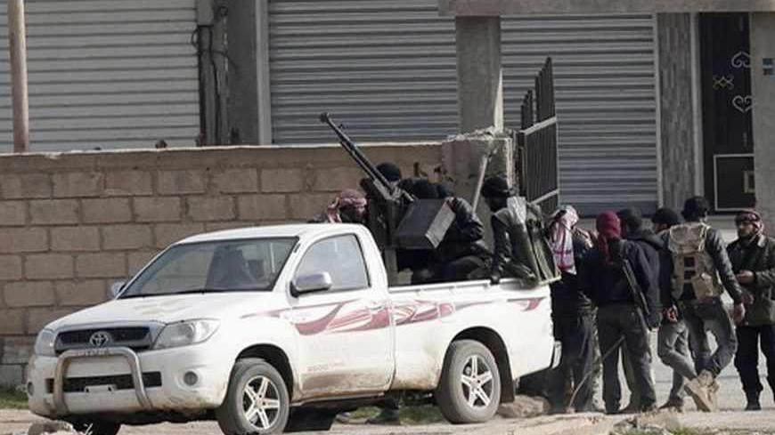 Members of the Free Syrian Army are seen in the northern Syrian town of Ras al-Ain as they are pictured from the Turkish border town of Ceylanpinar, Sanliurfa province January 25, 2013. REUTERS/Osman Orsal (SYRIA - Tags: POLITICS CONFLICT) - RTR3CXJT