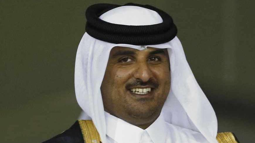 Madjid Bougherra (R) of Lekhwiya receives the trophy from Qatar's Crown Prince Sheikh Tamim bin Hamad al-Thani at Al-Sadd Stadium after the final match of the Crown Prince Cup soccer tournament against Al-Sadd in Doha May 4, 2013.    REUTERS/Fadi Al-Assaad (QATAR - Tags: SPORT SOCCER ROYALS) - RTXZAGP