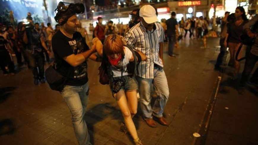 A protester is detained by plainclothes police officers during an anti-government protest at Taksim Square in Istanbul June 29, 2013. Thousands of protesters marched to Istanbul's Taksim Square on Saturday chanting slogans against the government and police after security forces killed a Kurdish demonstrator in southeastern Turkey. The protest had been planned as part of larger unrelated anti-government demonstrations that have swept through the country since the end of May, but became a voice of solidarity 