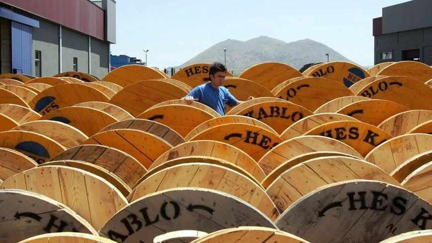 A worker checks cable drums at a factory in the city of Kayseri, central Turkey, June 27, 2006. The confident mood in Kayseri contrasts to the anxiety in Ankara, as they believe Turkey will weather the turbulence rocking its economy, resolve the tension between secularists and Islamists and stay the course to European Union membership. Picture taken June 27, 2006. To match feature TURKEY CRISIS REUTERS/Umit Bektas (TURKEY) - RTR1F0MZ