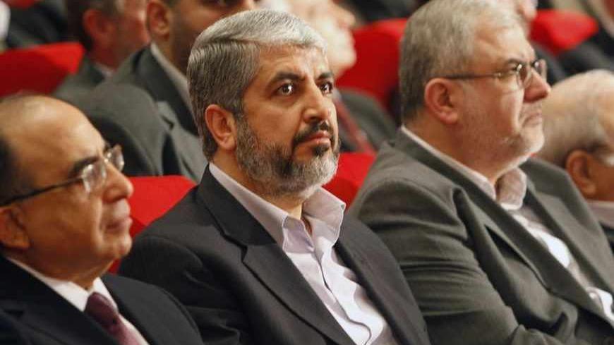 Hamas leader Khaled Meshaal (C), Head of Hezbollah's parliamentary bloc Mohamed Raad (R) and Lebanon's Minister of Education Hassan Mneimneh (L) listen to Lebanon's Hezbollah leader Sayyed Hassan Nasrallah speak via a video display during the Arab and International Forum to support the Resistance, in Beirut January 15, 2010. REUTERS/Jamal Saidi   (LEBANON - Tags: POLITICS) - RTR28WF6