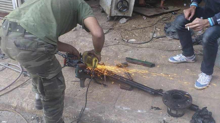 Workers repair machine gun at Jabal Al-Turkman near the coastal city of Latakia, October 30, 2012. REUTERS/Abu Al-Hassan/Shaam News Network/Handout (SYRIA - Tags: POLITICS CIVIL UNREST) FOR EDITORIAL USE ONLY. NOT FOR SALE FOR MARKETING OR ADVERTISING CAMPAIGNS. THIS IMAGE HAS BEEN SUPPLIED BY A THIRD PARTY. IT IS DISTRIBUTED, EXACTLY AS RECEIVED BY REUTERS, AS A SERVICE TO CLIENTS - RTR39SAY