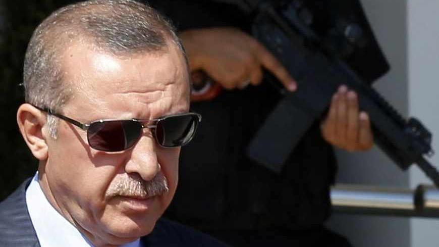 Turkey's Prime Minister Tayyip Erdogan walks to his plane as he leaves for Turkmenistan, at Esenboga Airport in Ankara August 15, 2013.  Erdogan called on Thursday for the U.N. Security Council to convene quickly and act after what he described as a massacre in Egypt, during a news conference in Ankara. REUTERS/Umit Bektas (TURKEY - Tags: POLITICS) - RTX12M4A