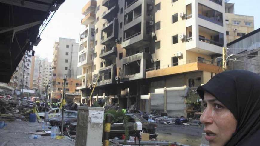 A woman reacts as she looks at the site of a car bomb that occurred on Thursday in Beirut's southern suburbs, August 16, 2013.  The death toll from a car bomb which ripped through the southern Beirut stronghold of Lebanon's militant group Hezbollah rose on Friday to 24, and the government said it was investigating whether the blast was a suicide attack. REUTERS/Sharif Karim   (LEBANON - Tags: POLITICS CIVIL UNREST) - RTX12NFG