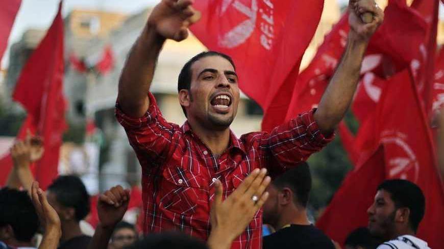 A Palestinian shouts slogans during a rally marking the 12th anniversary of the killing of Abu Ali Mustafa, leader of the Popular Front for the Liberation of Palestine (PFLP), in Gaza City August 27, 2013. Abu Mustafa was killed in an Israeli missile attack in Ramallah in 2001. REUTERS/Suhaib Salem (GAZA - Tags: POLITICS CIVIL UNREST ANNIVERSARY) - RTX12Y2J