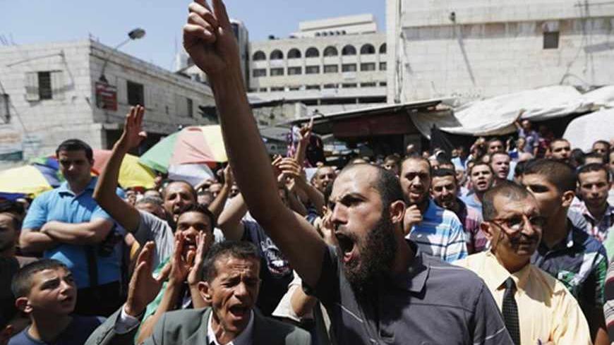 Palestinians shout slogans during a rally in solidarity with Egypt's deposed Islamist President Mohamed Mursi and in protest of the recent violence in Egypt organized by Hamas movement in the West Bank city of Ramallah, August 16, 2013. Deeply polarised Egypt braced for renewed confrontation on Friday after the Muslim Brotherhood called for a nationwide march of millions to show anger at a ferocious security crackdown on Islamists in which hundreds were killed. REUTERS/Mohamad Torokman (WEST BANK - Tags:
