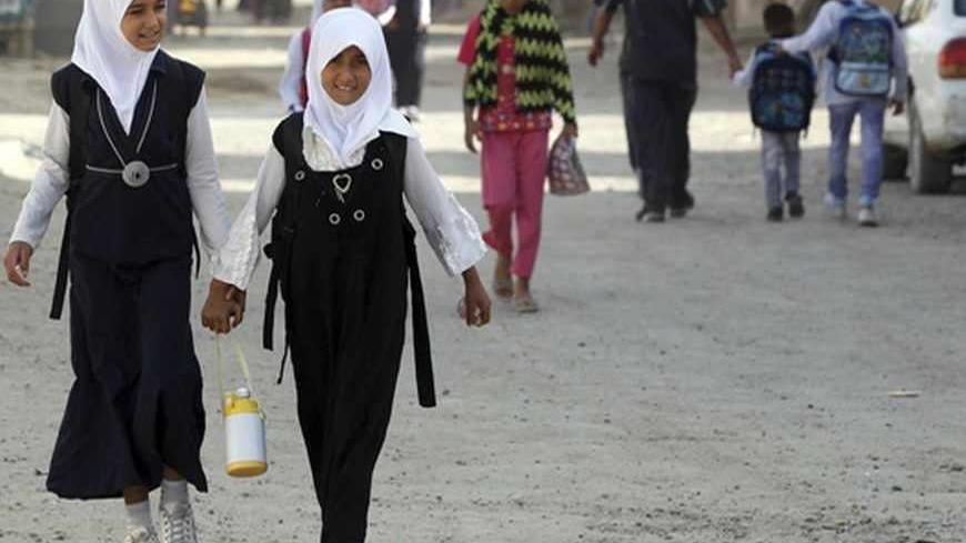 Students walk to class on the first day of the new school term in Baghdad's Sadr City September 23, 2012. REUTERS/Mohammed Ameen (IRAQ - Tags: SOCIETY EDUCATION) - RTR38B41