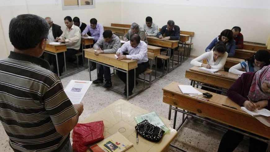 Syrian Kurds practise reading the Kurdish language at a school in Derik, Al-Hasakah October 31, 2012. Iraqi Kurdish President Masoud Barzani warned Kurds in Syria against being sucked into the "fires of discord," urging them to preserve Kurdish unity as tensions between rival factions threaten to spillover into violence. Syria's Kurds see the war ravaging their country as an unprecedented opportunity to gain the kind of freedoms enjoyed by their ethnic kin in neighbouring Iraq, where they live autonomously
