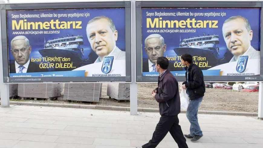 Pedestrians look at billboards with the pictures of Turkey's Prime Minister Tayyip Erdogan (R) and his Israeli counterpart Benjamin Netanyahu (L), in Ankara March 25, 2013. Turkey's Prime Minister Tayyip Erdogan said on Saturday an Israeli apology for the 2010 deaths of nine Turkish pro-Palestinian activists that was brokered by U.S. President Barack Obama met Turkey's conditions and signalled its growing regional clout. The billboard reads, "Israel apologized to Turkey. Dear Prime Minister (Erdogan), We ar