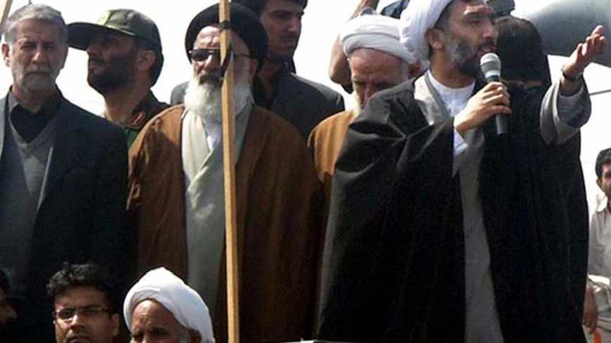 Iran's Interior Minister Mostafa Pour-Mohammadi (R) speaks during a funeral ceremony for victims who were killed in an attack by bandits in Zabol, 1,605 km (997 miles) south of Tehran March 18, 2006. REUTERS/IRNA - RTR17CL9