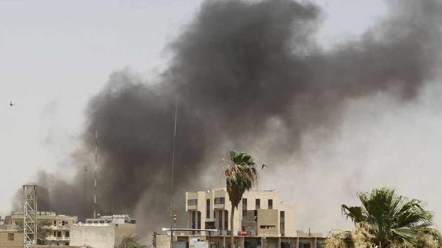 Smoke rises from the site of a bomb attack in Baghdad July 16, 2011. A parked car bomb targeting a night club killed two people and wounded nine others in central Baghdad, police and hospital sources said. Another police source said only six people were wounded by a roadside bomb. REUTERS/Saad Shalash (IRAQ - Tags: CONFLICT) - RTR2OXMP