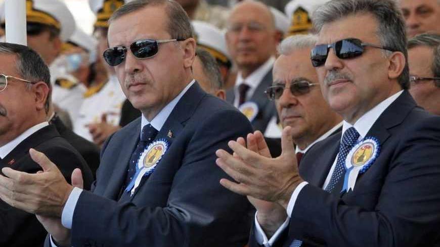 Turkey's President Abdullah Gul (R) and Turkey's Prime Minister Recep Tayyip Erdogan attend a delivery ceremony for the first nationally designed combat ship TCG Heybeliada at the Tuzla Naval shipyard in Istanbul September 27, 2011. REUTERS/Osman Orsal (TURKEY - Tags: POLITICS MILITARY) - RTR2RWLG