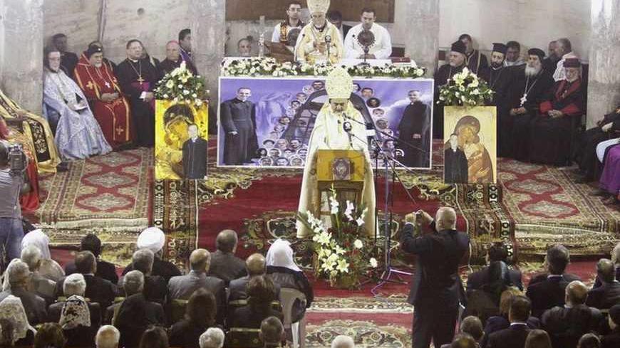 Iraq's Assyrian Catholic residents hold a memorial Mass marking the first anniversary of victims killed in a militant attack on the Our Lady of Salvation Church in 2010, at the Church in Baghdad October 31, 2011. Fifty-two hostages and police were killed during an attack on the church on October 31, 2010. REUTERS/Saad Shalash (IRAQ - Tags: RELIGION SOCIETY ANNIVERSARY POLITICS) - RTR2TGJ6