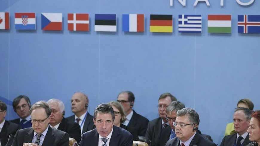 North Atlantic Treaty Organization (NATO) Secretary General Anders Fogh Rasmussen (2nd L) gives the opening remarks during the Defense Ministers' Meeting with Deputy Secretary General Alexander "Sandy" Vershbow (L) at the NATO headquarters in Brussels, February 21, 2013. U.S. Secretary of Defense Leon Panetta is attending the NATO meetings and holding bilateral meetings with other defense officials. REUTERS/Chip Somodevilla/Pool (BELGIUM - Tags: MILITARY POLITICS) - RTR3E2RV