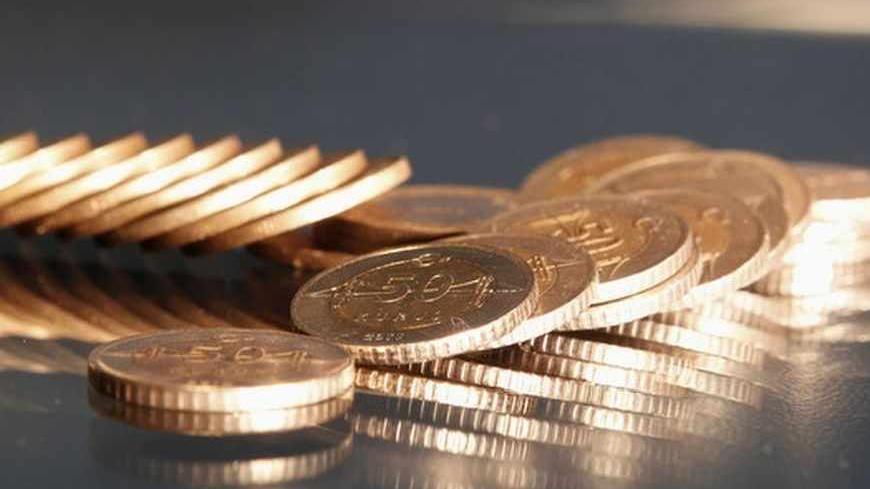 Turkey's lira coins are seen in this picture illustration taken in Istanbul July 23, 2013. Turkey's central bank raised interest rates on Tuesday and said it would, if necessary, take further steps to stop the lira from falling. The move - a rise in the overnight lending rate to 7.25 percent from 6.5 percent - was a reaction to capital outflows that have knocked the lira down as much as 9 percent against the dollar. REUTERS/Osman Orsal (TURKEY - Tags: BUSINESS) - RTX11W1Y