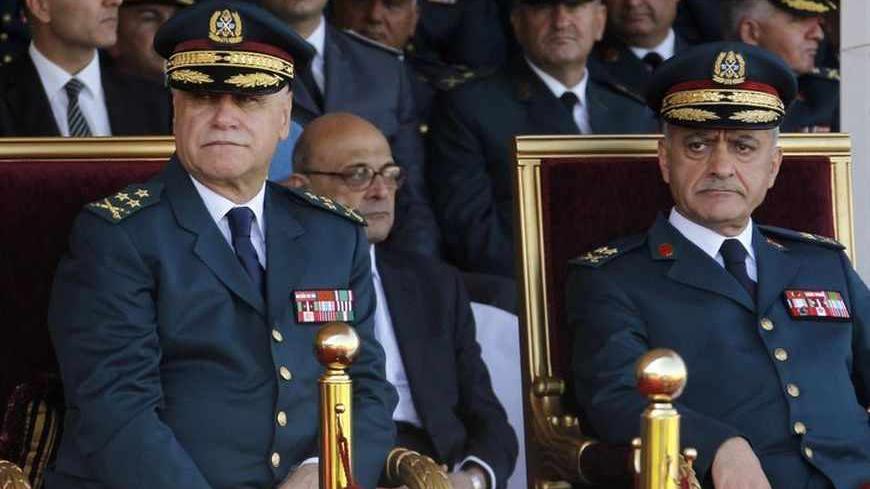 Lebanese Army Commander General Jean Kahwaji (L) and Army Chief of Staff General Walid Salman attend a graduation parade for Lebanese officer cadets at a military academy in Fayadyeh, near Beirut, marking the 68th Army Day, August 1, 2013. Lebanon's defence minister extended the term of the army chief on Wednesday to avoid a vacuum in military leadership at a time when the country is facing violence linked to Syria's war and political paralysis. The extension by two years of Army Chief Jean Kahwaji's posti