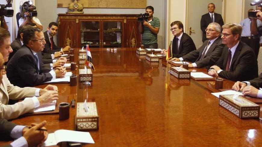 Egypt's interim Foreign Minister Nabil Fahmy (3rd L) speaks as German Foreign Minister Guido Westerwelle (2nd R) looks on during their meeting in Cairo August 1, 2013. Germany urged Egypt to avoid "the appearance of selective justice" on Thursday amid a crackdown on deposed President Mohamed Mursi's Muslim Brotherhood, which remained defiantly dug in at a protest camp the police have orders to remove. REUTERS/Mohamed Abd El Ghany (EGYPT - Tags: POLITICS CIVIL UNREST) - RTX126WM